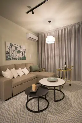 a living room with a couch and two tables at Acropolis Panorama Luxury Loft 8th fl Balcony View in Athens