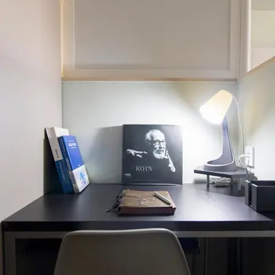 a desk with a lamp and books on it at Acropolis Panorama Luxury Loft 8th fl Balcony View in Athens