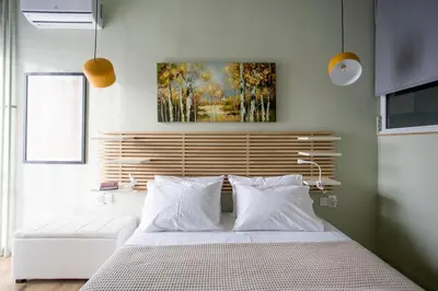 a bedroom with a bed and a painting on the wall at Acropolis Panorama Luxury Loft 8th fl Balcony View in Athens