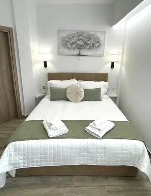 a bedroom with a bed with two towels on it at Athens Praxitelous Vibes & Nest in Athens