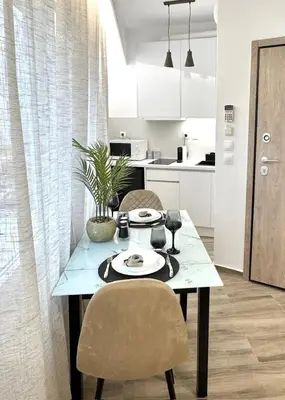 a dining table with two chairs in a kitchen at Athens Praxitelous Vibes & Nest in Athens