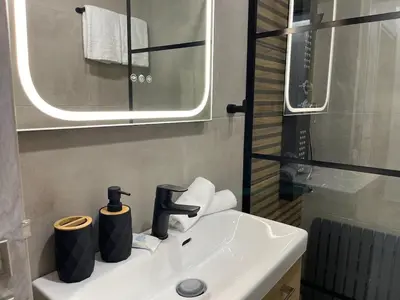 a bathroom with a sink with a mirror and a sink at Athens Praxitelous Vibes & Nest in Athens