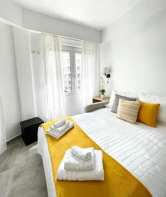 a bedroom with a large bed with towels on it at Athens Praxitelous Vibes & Nest in Athens