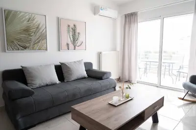 a living room with a couch and a table at Stylish Apartment in Piraeus -F9 in Piraeus