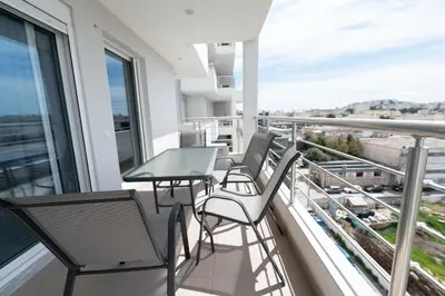 a balcony with chairs and a table on a building at Stylish Apartment in Piraeus -F9 in Piraeus
