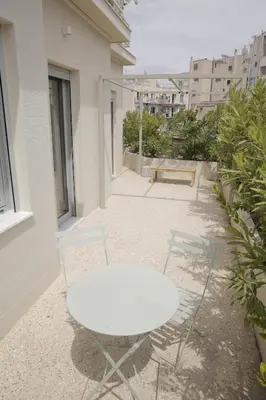 a white table and two chairs on a balcony at Contemporary Athenian Escape GHH in Athens