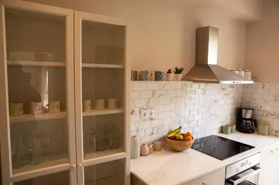 a kitchen with a counter with a cabinet and a bowl of fruit at Contemporary Athenian Escape GHH in Athens