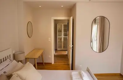 a bedroom with a bed and a mirror on the wall at Contemporary Athenian Escape GHH in Athens