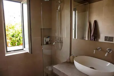 a bathroom with a tub and a shower and a sink at Contemporary Athenian Escape GHH in Athens