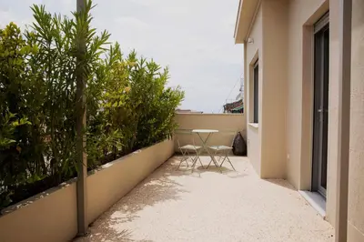 a patio with two chairs and a table on a building at Contemporary Athenian Escape GHH in Athens