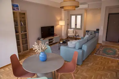 a living room with a blue couch and a table at Contemporary Athenian Escape GHH in Athens