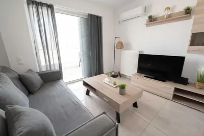 a living room with a couch and a tv at Top-Floor Retreat in Piraeus-H5 in Piraeus