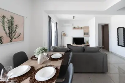 a living room with a table and a couch at Top-Floor Retreat in Piraeus-H5 in Piraeus