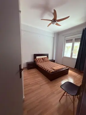 a bedroom with a bed and a ceiling fan at The beautiful house behind Kallimarmaro stadium in Athens