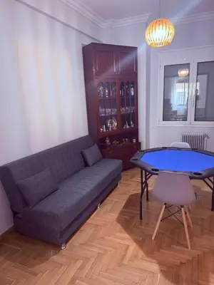 a living room with a couch and a table at The beautiful house behind Kallimarmaro stadium in Athens