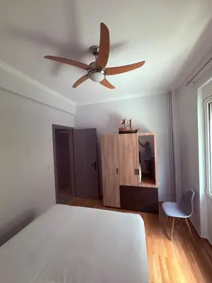 a bedroom with a bed and a ceiling fan at The beautiful house behind Kallimarmaro stadium in Athens