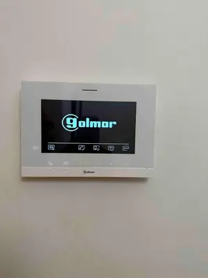 a television on a wall with the gilmer on it at The beautiful house behind Kallimarmaro stadium in Athens