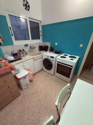 a kitchen with a stove and a washing machine at The beautiful house behind Kallimarmaro stadium in Athens