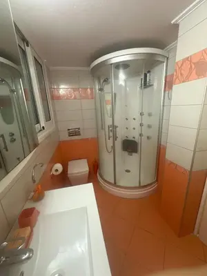 a bathroom with a shower and a sink and a toilet at The beautiful house behind Kallimarmaro stadium in Athens