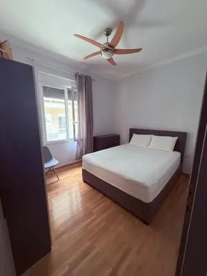 a bedroom with a bed and a ceiling fan at The beautiful house behind Kallimarmaro stadium in Athens