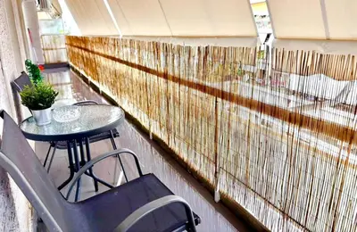 a balcony with a table and chairs and a fence at Alimos Apartment near Edem Beach and the Sea with 2 Bedroom in Athens