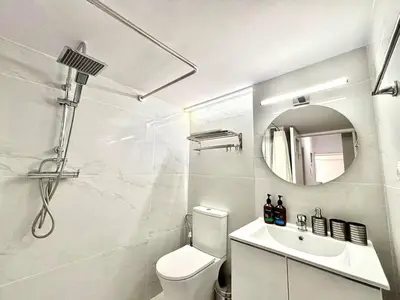 a bathroom with a toilet and a sink and a mirror at Alimos Apartment near Edem Beach and the Sea with 2 Bedroom in Athens