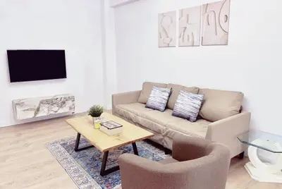 a living room with a couch and two chairs and a table at Alimos Apartment near Edem Beach and the Sea with 2 Bedroom in Athens