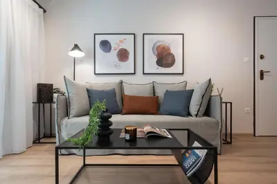 a living room with a couch and a table at Modern Apartment in Athens with Balcony in Athens