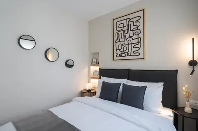 a bedroom with a white bed with blue pillows at Modern Apartment in Athens with Balcony in Athens