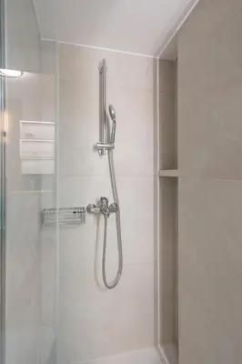 a shower in a bathroom with a glass door at Modern Apartment in Athens with Balcony in Athens