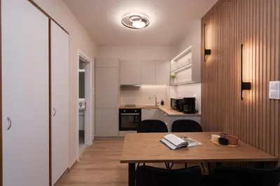 a small kitchen with a wooden table in a room at Modern Apartment in Athens with Balcony in Athens