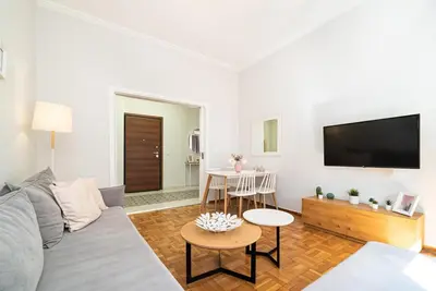a living room with a couch and a flat screen tv at Acropolis Anemone Apartment in Athens