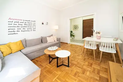 a living room with a couch and a table at Acropolis Anemone Apartment in Athens