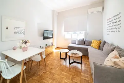 a living room with a couch and a table at Acropolis Anemone Apartment in Athens