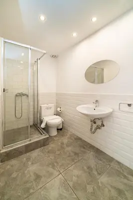 a bathroom with a shower and a toilet and a sink at Acropolis Anemone Apartment in Athens