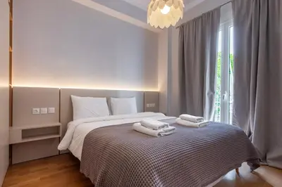 a bedroom with a bed with towels on it at Stylish 2BDR Exarchia Apt with Balcony and Workspace in Athens