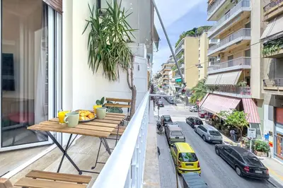 an apartment balcony with a table and a street at Stylish 2BDR Exarchia Apt with Balcony and Workspace in Athens