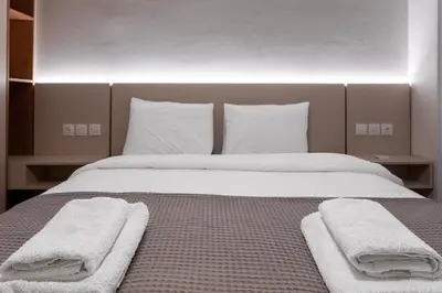 a bedroom with a bed with two towels on it at Stylish 2BDR Exarchia Apt with Balcony and Workspace in Athens