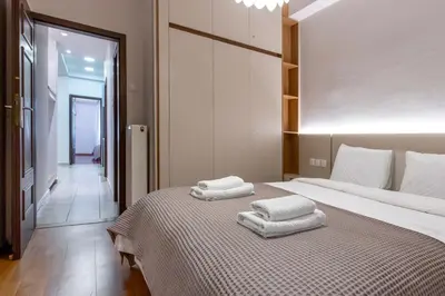 a bedroom with a bed with two towels on it at Stylish 2BDR Exarchia Apt with Balcony and Workspace in Athens