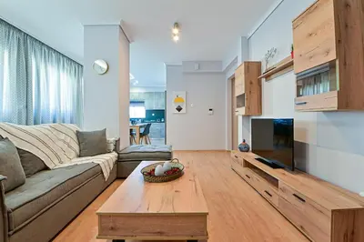a living room with a couch and a coffee table at Elegant Sea View Stay - Piraeus Port in Piraeus