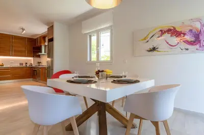 a white dining room with a white table and chairs at Cozy & Renovated, Walk to beach in Athens