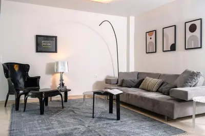 a living room with a couch and a table and chairs at Cozy & Renovated, Walk to beach in Athens