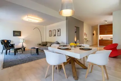 a living room with a white table and chairs at Cozy & Renovated, Walk to beach in Athens