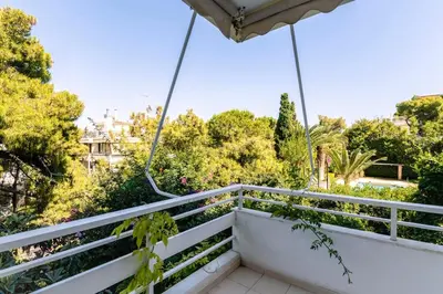 a balcony with a view of trees at Cozy & Renovated, Walk to beach in Athens