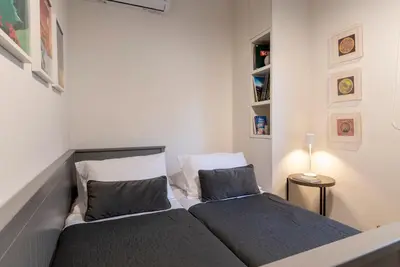 a bedroom with two beds and a lamp on a table at Cozy & Renovated, Walk to beach in Athens