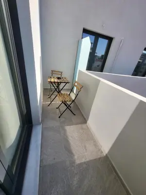 a balcony with a table and chairs in a building at Diamond Piraeus Port in Piraeus