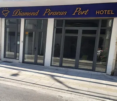 a hotel with a blue sign on the front of a building at Diamond Piraeus Port in Piraeus