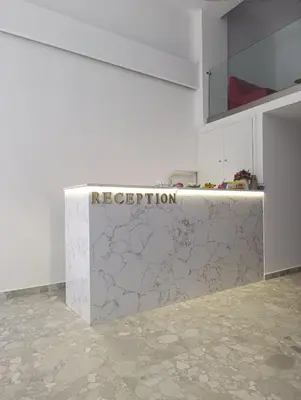 a white kitchen with a counter with the words ne deception at Diamond Piraeus Port in Piraeus