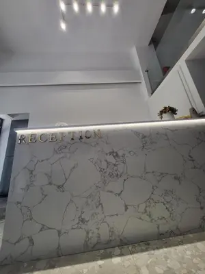 a reception counter in a room with a sign that reads reception at Diamond Piraeus Port in Piraeus