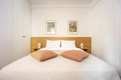 a bedroom with a white bed with two pillows at Attica Skyline Living! in Athens